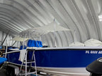 Blue center console boat with two custom National Canvas sun shades, one over the helm and one aft