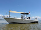 Side profile of a Blue Wave Makaira center console with a custom bow sun shade flying