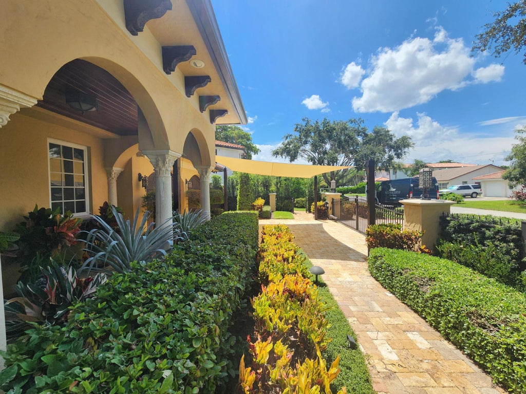 Custom shade sail over a residential walkway in South Florida, built and installed by National Canvas