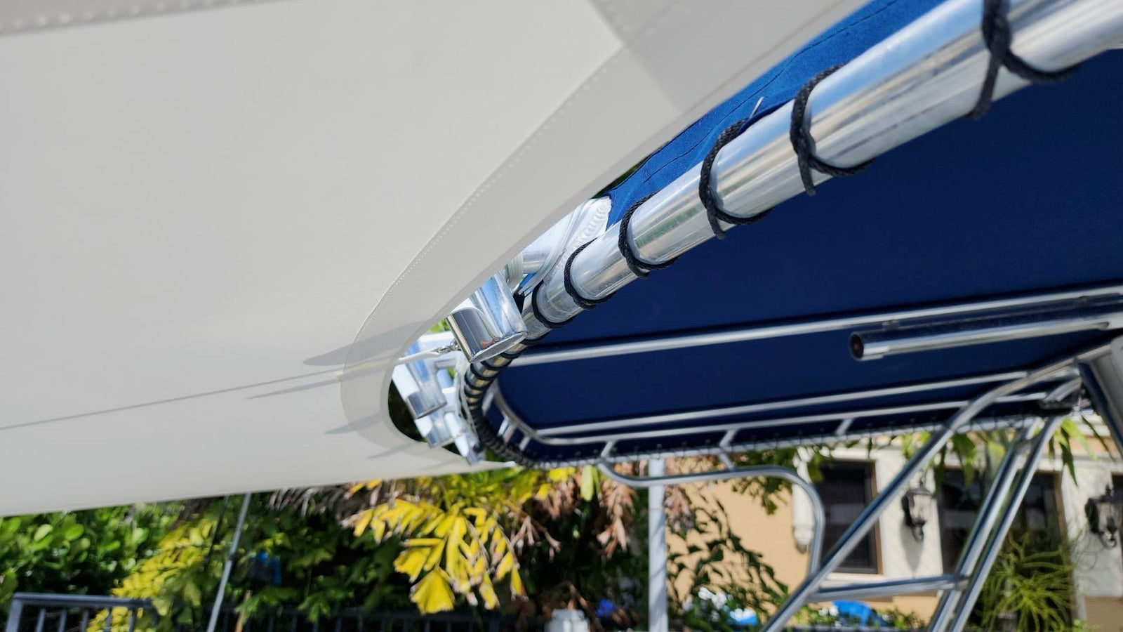 Close-up of navy lacing on a stainless steel sun shade pole