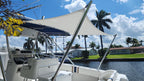 Custom boat sun shade on an Intrepid center console, cream two-pole shade under a navy T-top