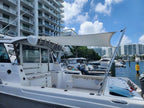 Two-pole boat sun shade deployed off the side at a marina dock