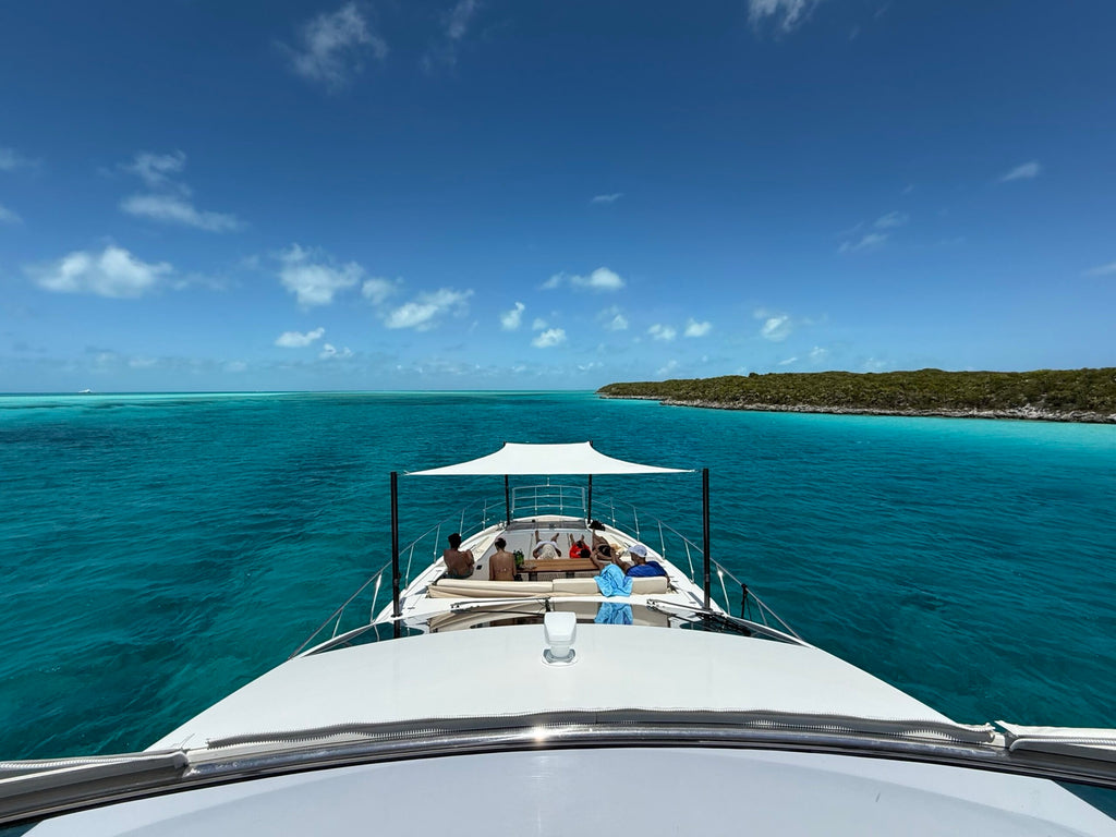 Custom foredeck Sunshade over the bow seating of a motor yacht anchored in the Bahamas