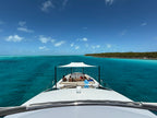 Custom foredeck Sunshade over the bow seating of a motor yacht anchored in the Bahamas